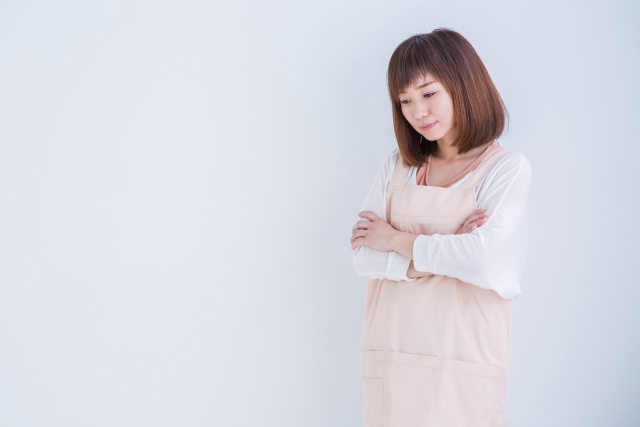 掃除をしながら悩む女性